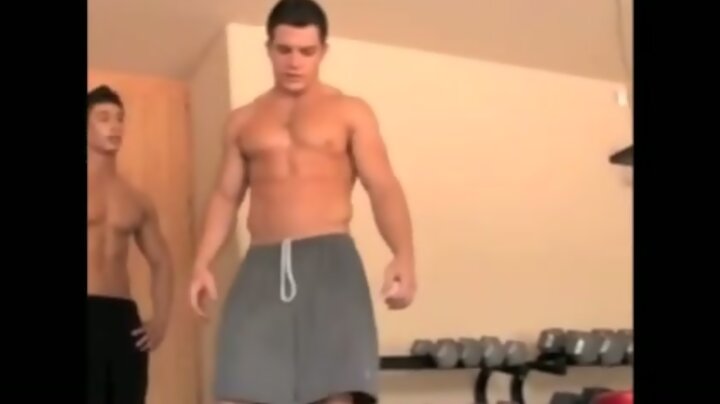 Naked gym buddies help each other out